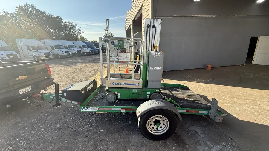 Genie Runabout vertical mast lift secured on trailer for delivery